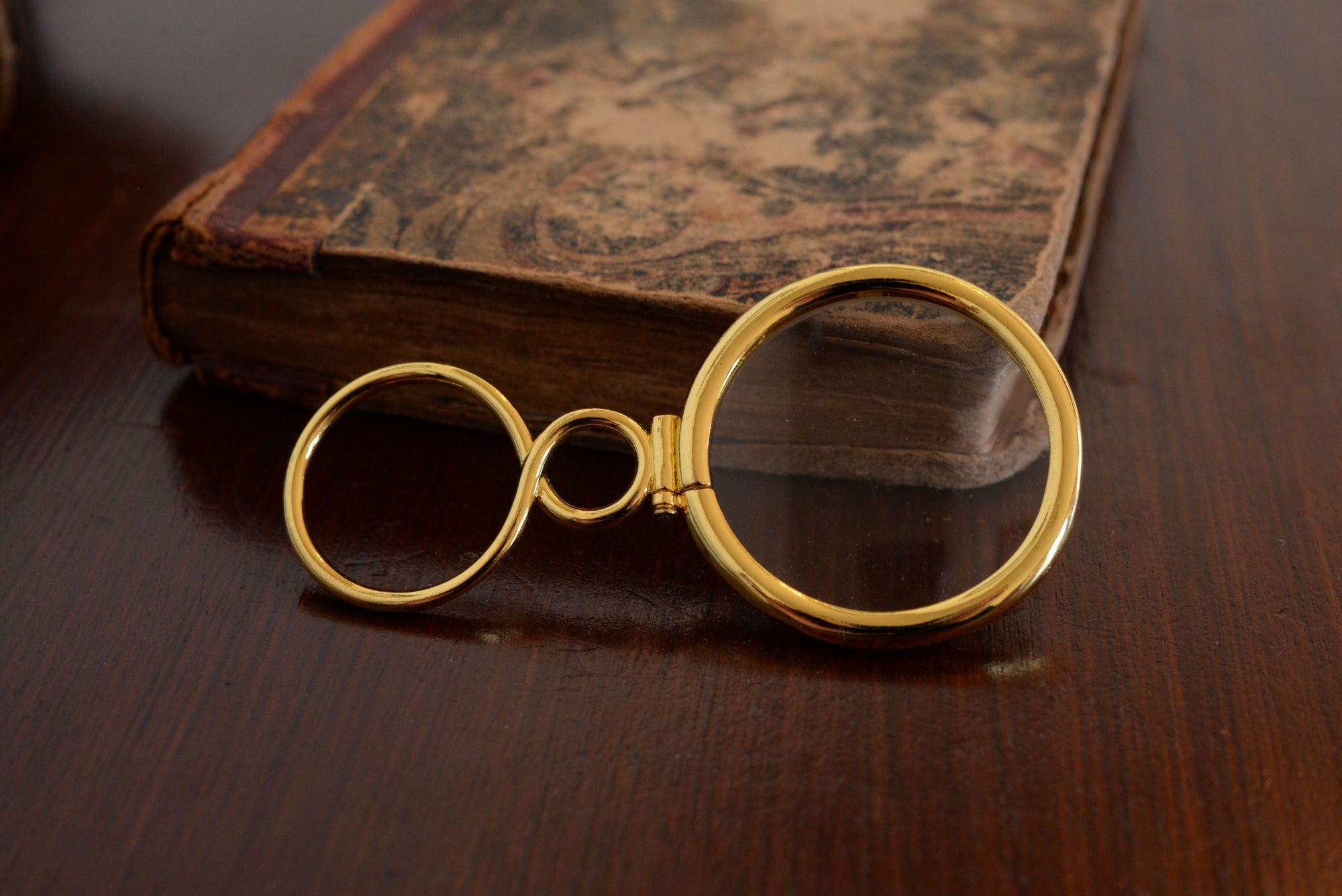 18th century magnifying glass on book