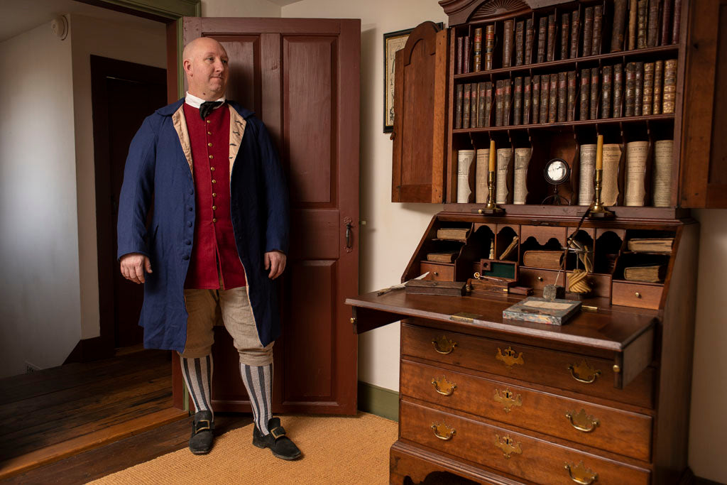 Red 1760&#39;s Waistcoat being worn in an Early American home by model in Colonial clothing.