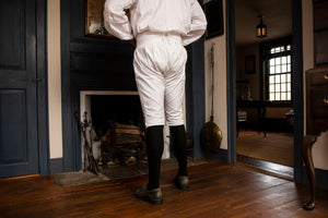 Back view of White Cotton Breeches being worn in Colonial American home