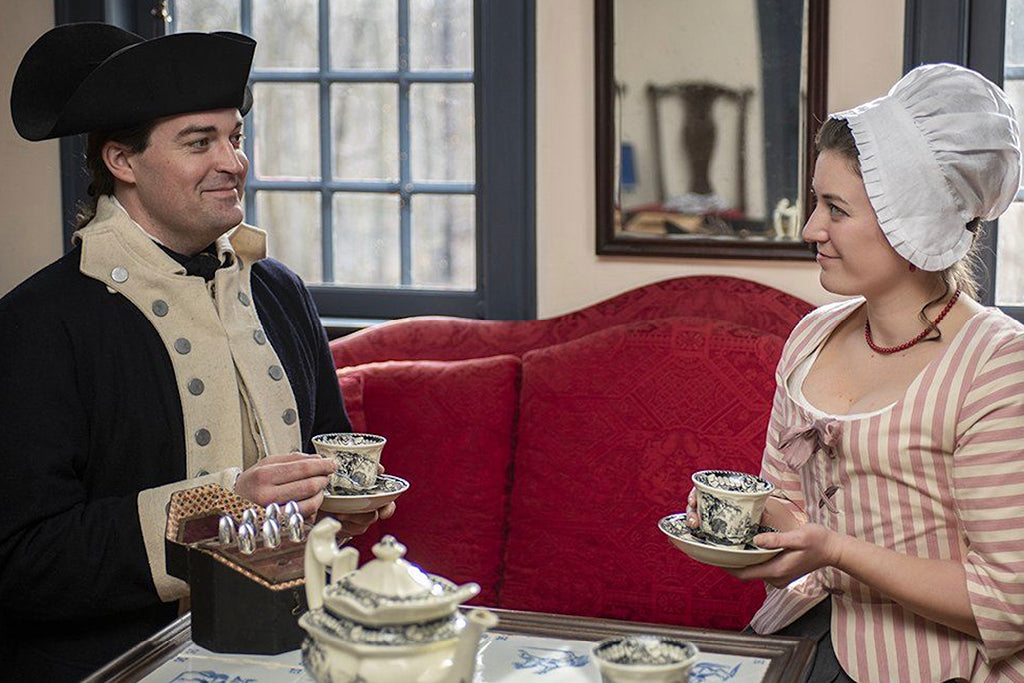 Revolutionary War Soldier wearing Regimental Coat with Blue and White Facings in a Colonial American home.